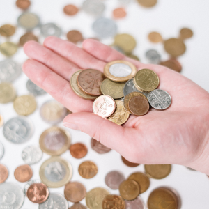 hand holding a selection of coins